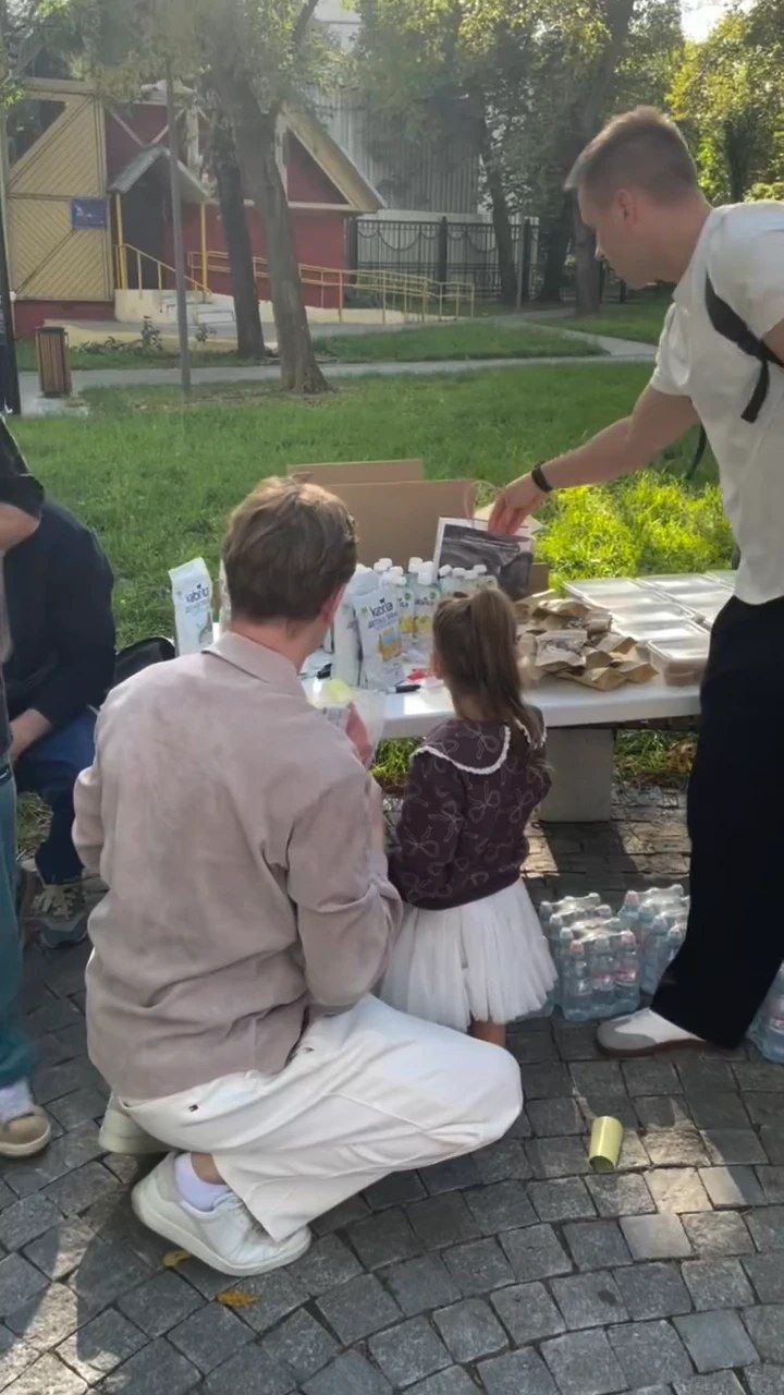 Отец и девочка у стола с угощениями